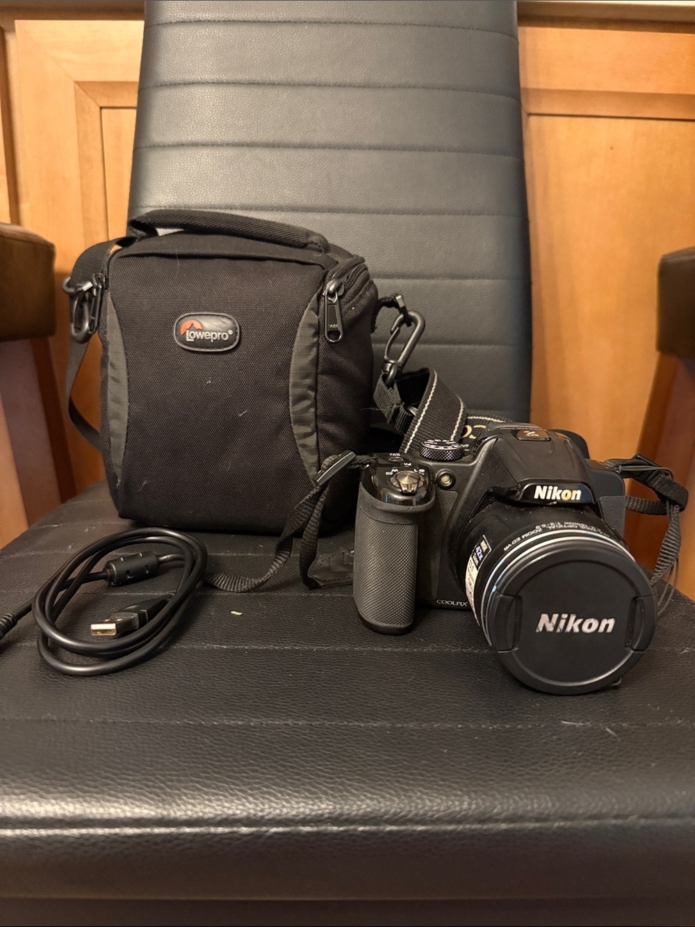 Nikon Black DSLR Camera with Black Lowepro Case and USB Cable